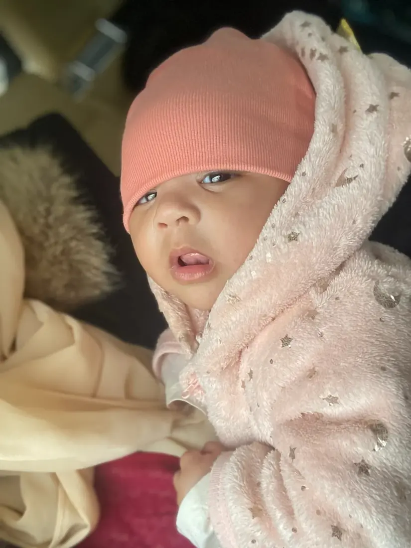 A newborn bundled warmly in pink
